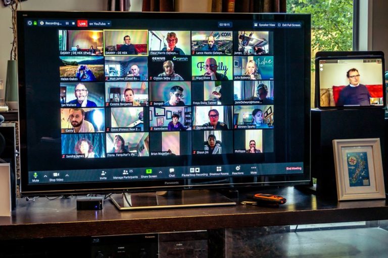 A tv screen with a group of people on it.