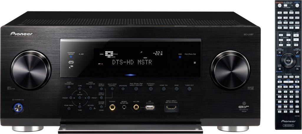 A black av receiver with a remote control.